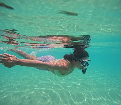 Woman swimming in Seven Commandos Beach by Rhey Ann Renonos